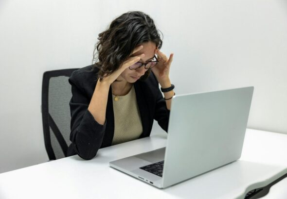 a woman sitting in front of a laptop computer