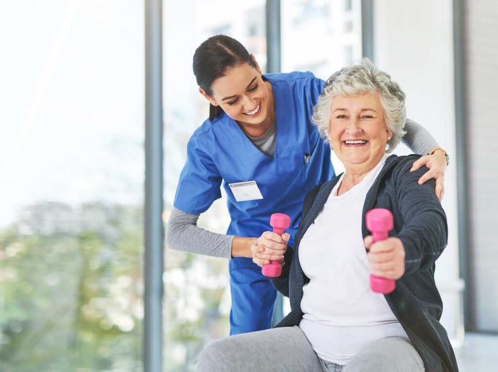 Therapist helping woman with gray hair to exercise