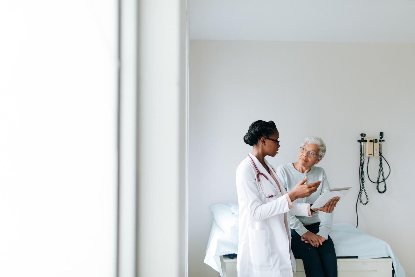 Doctor explaining something to an older woman